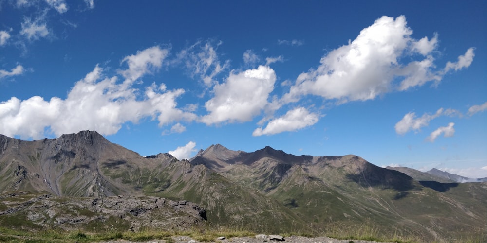 green mountains under a cloudy sky during daytime