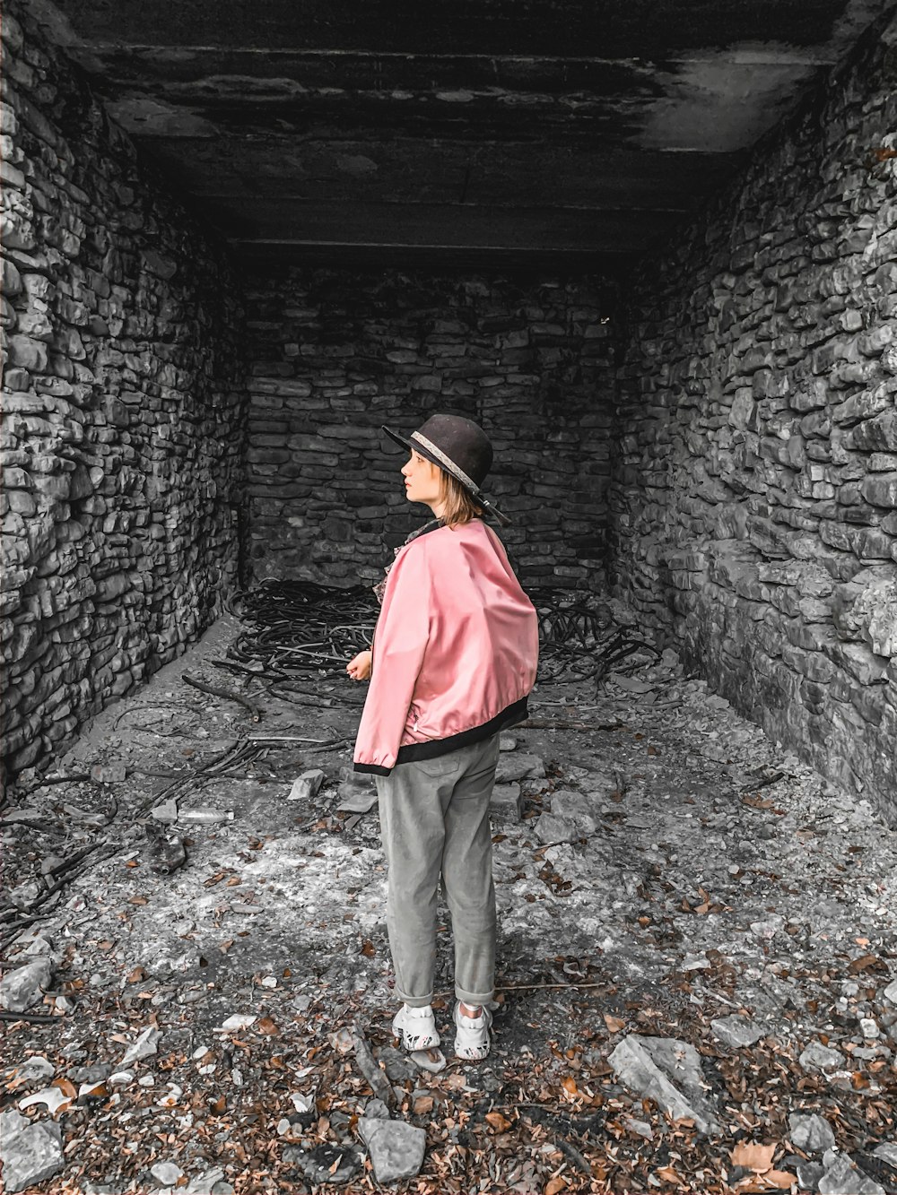 woman standing near black brick walls