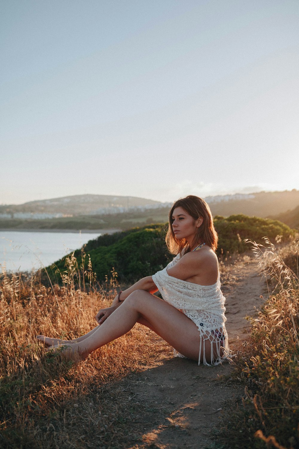 woman sitting near river