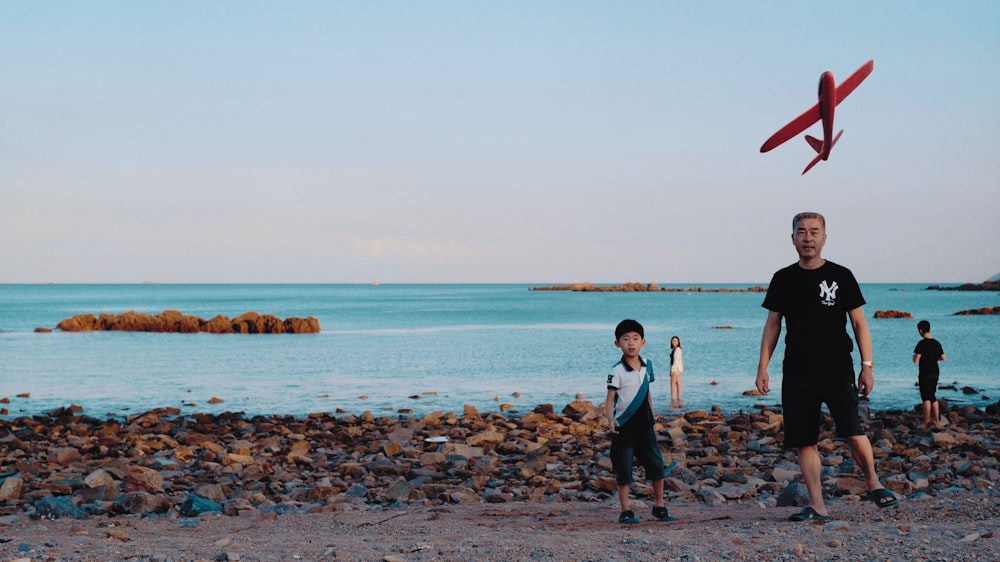 man and boy standing on shore