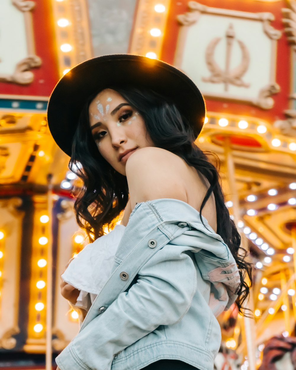 low-angle photography of woman wearing gray denim jacket and black cowboy hat