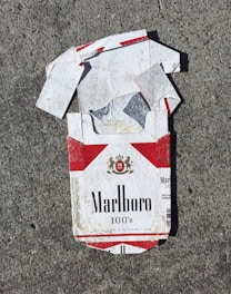red Marlboro cigarette box on gray surface