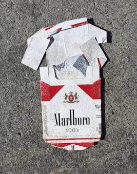 red Marlboro cigarette box on gray surface