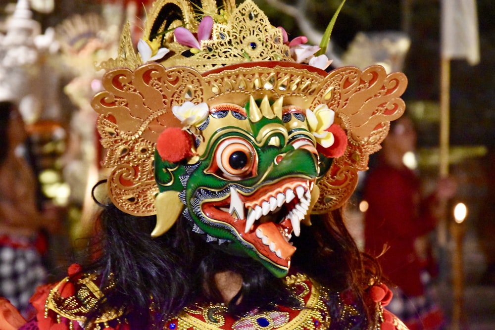 person wears Asian traditional mask