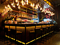 Bar and restaurant interior with illuminated shelves and seating