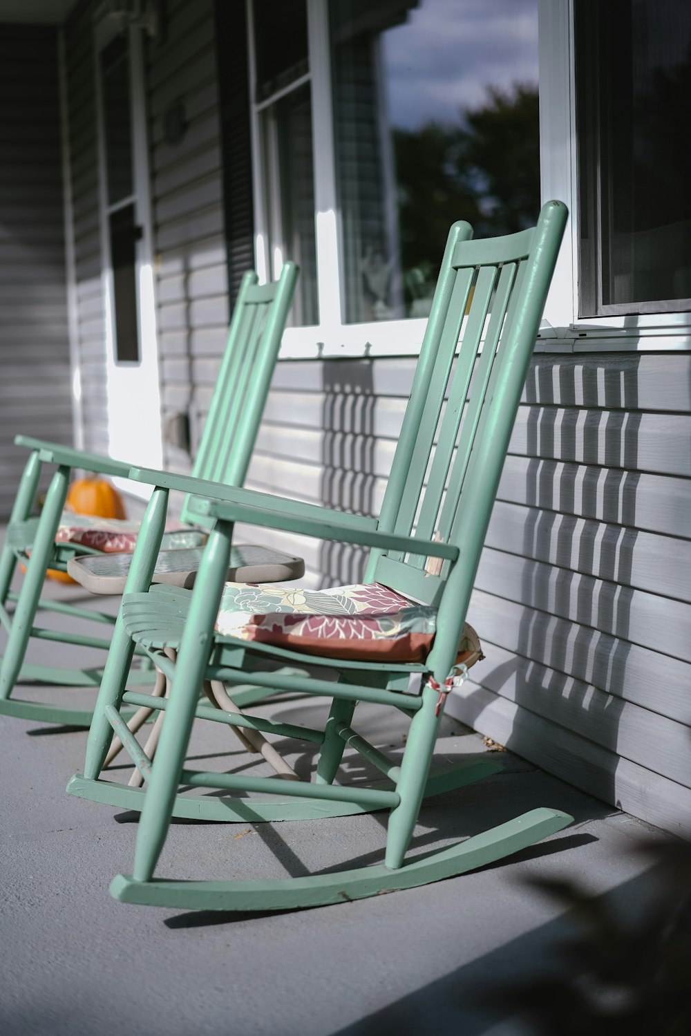 empty gray wooden rocking chairs