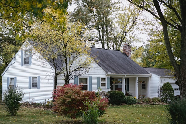 view of white painted house with chimney