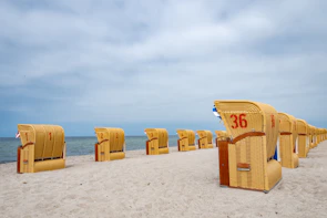 Shorenest's colorful beach chairs lined up neatly on the sandy shore.