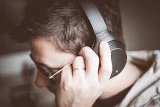 man using black Sony headphones