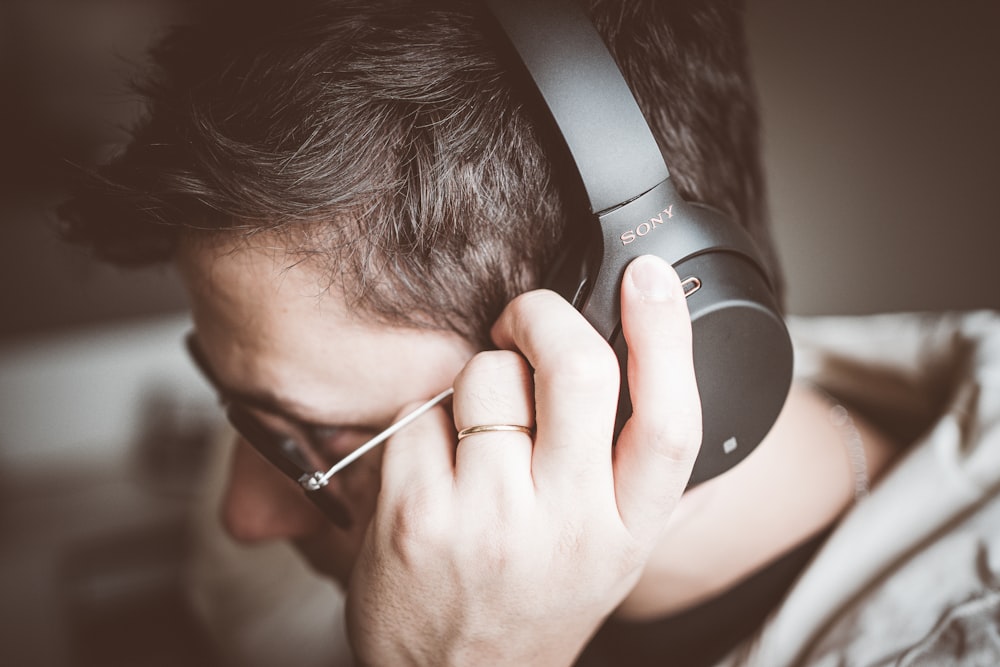 man using black Sony headphones