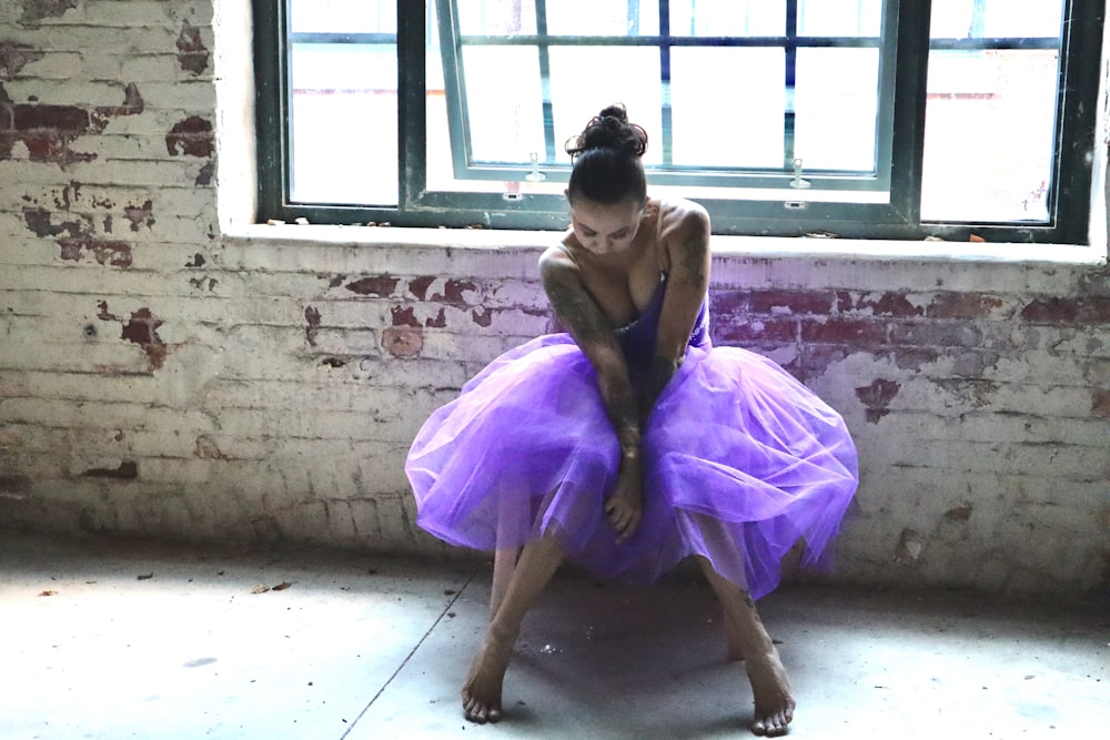 woman wearing purple dress sitting on chair