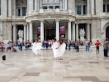 Traditional Basque dancers performing in front of a historic stone building.