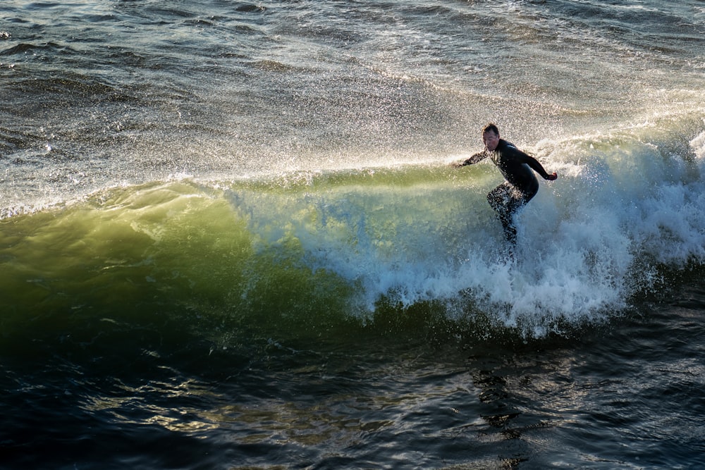 time lapse photography of man surfing in the beach