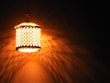 Soft glowing lanterns casting intricate shadows in a cozy, warmly decorated room celebrating Ramadan.