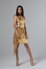 woman wearing gold sequined sleeveless dress with fringe