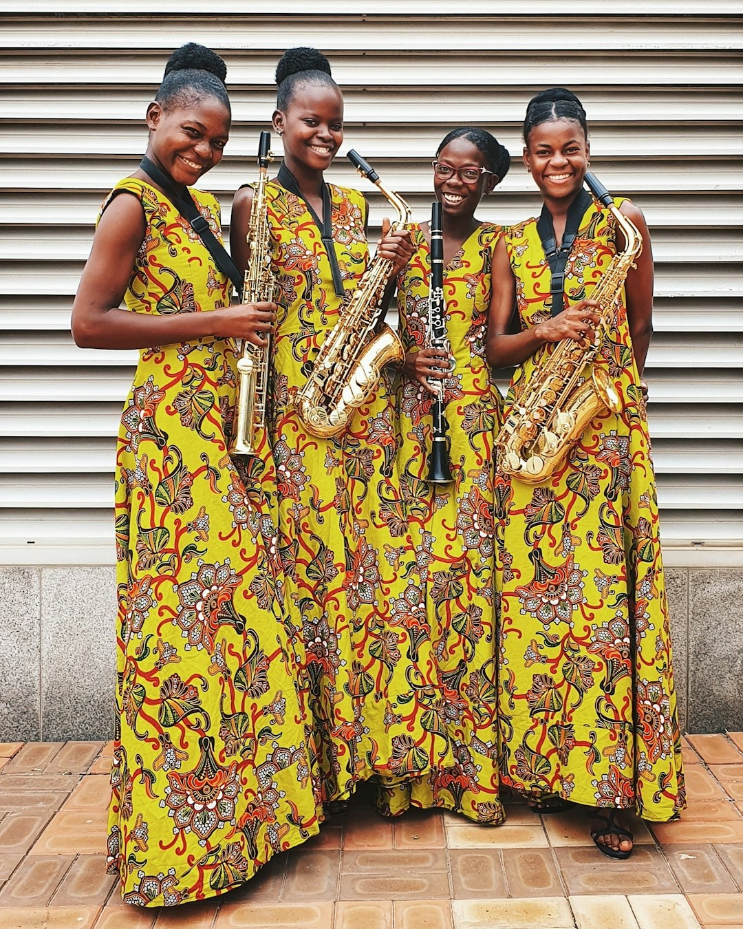 four women playing wind instrument