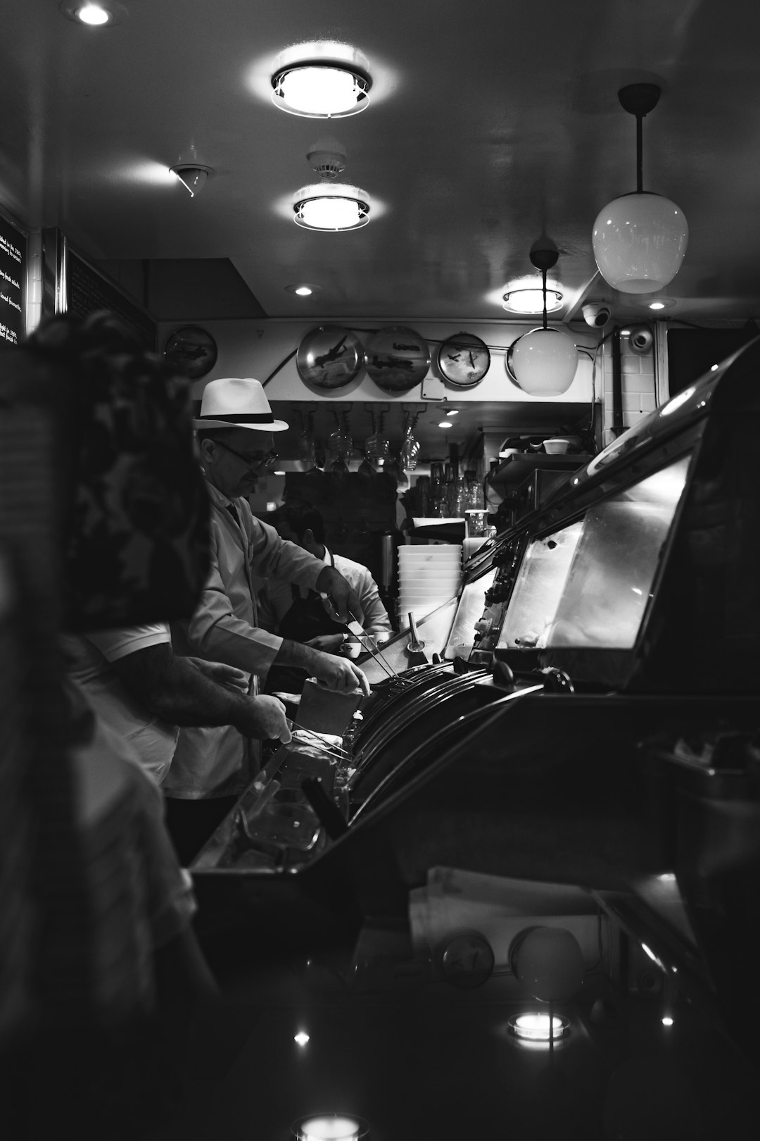grayscale photography of people playing arcade game