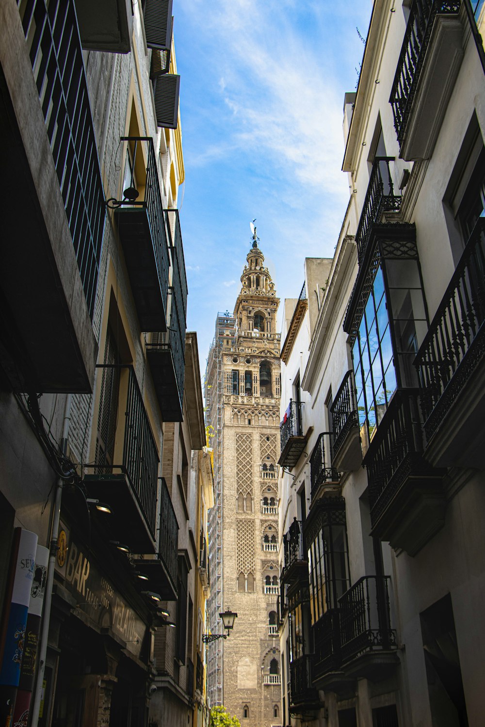 cathedral tower between buildings