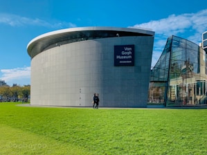 Silhouette of Van Gogh’s Starry Night alongside a classic museum building.