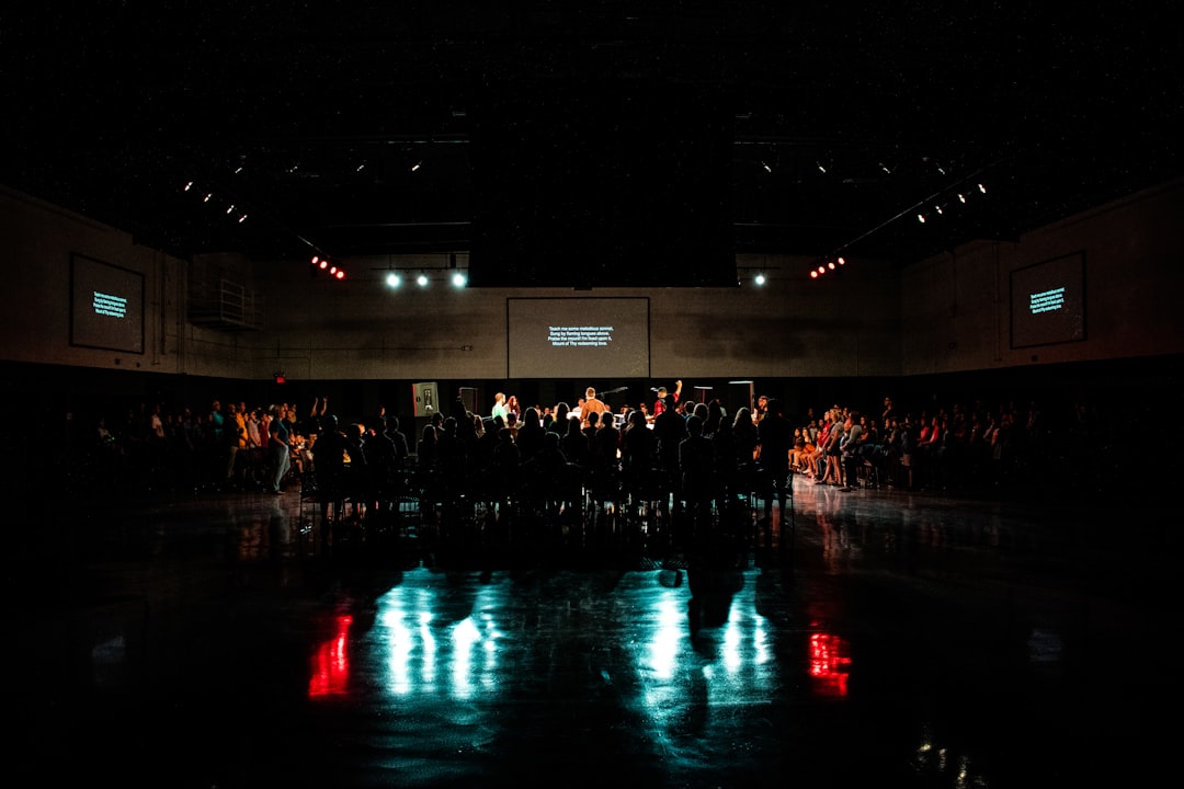 crowd sitting beside body of water