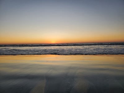 A serene image of a beautiful beach at sunset inviting relaxation.