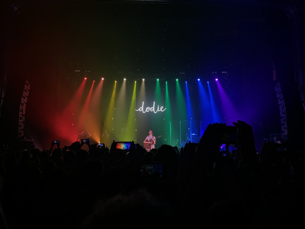 crowd of people watching a man perform on stage