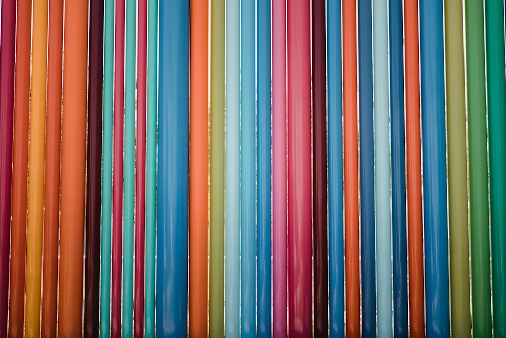 a group of multicolored plastic straws sitting on top of each other