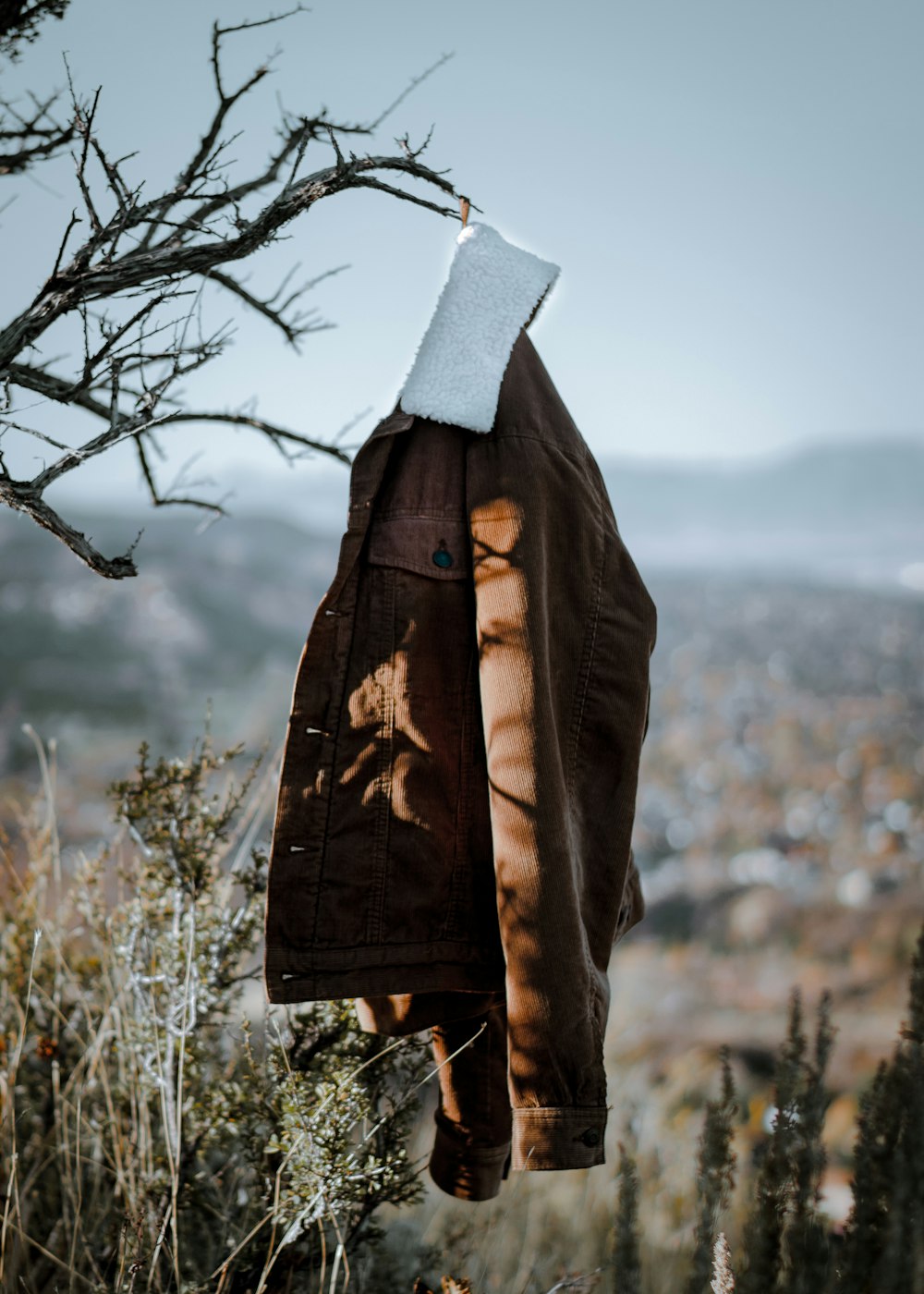 shallow focus photo of brown jacket