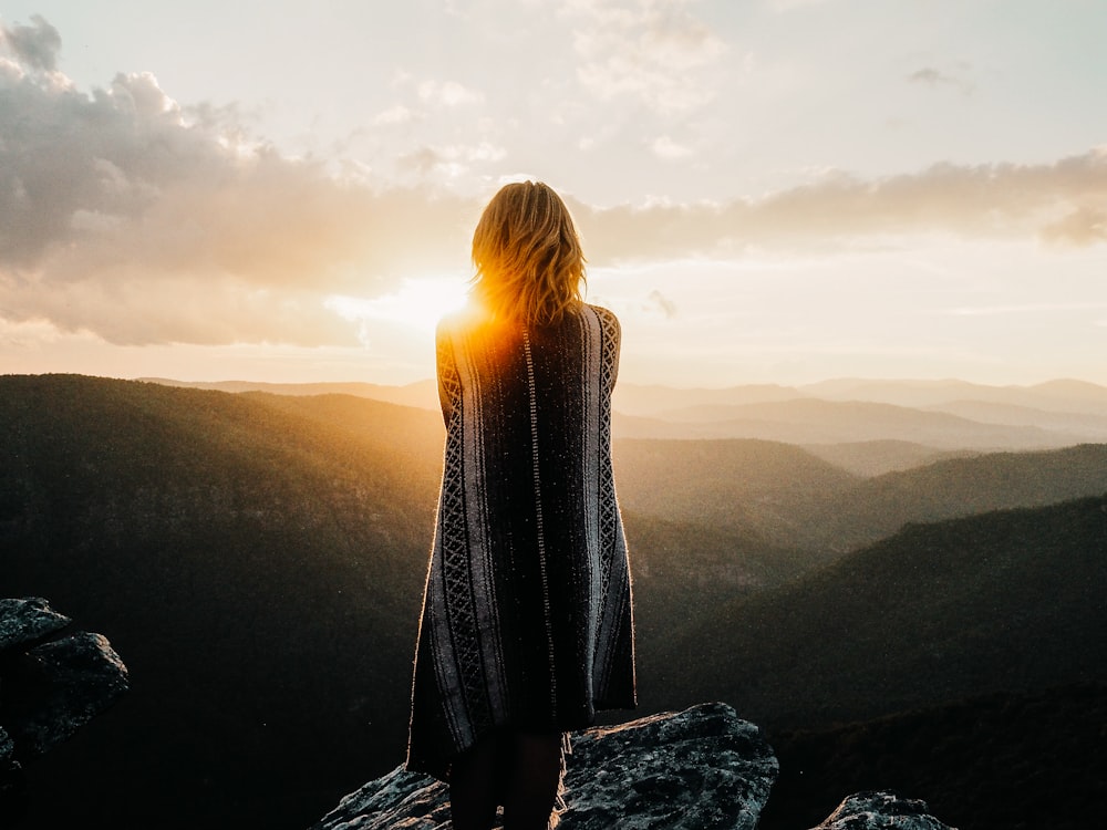 woman overlooking mountains during golden hour