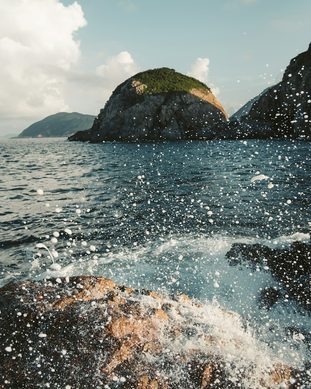 time lapse photography of waves splashing on rocks