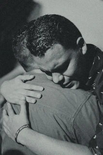 Black and white photo of a father and daughter embracing, capturing deep emotional connection.