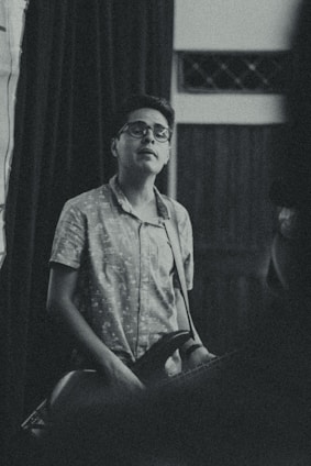 A cozy scene of a person wearing a samba-themed t-shirt, with musical notes and a tambourine in the background.