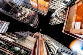 Nighttime cityscape with glowing surveillance cameras watching over buildings