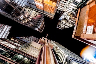Night view of a city skyline monitored by security cameras.