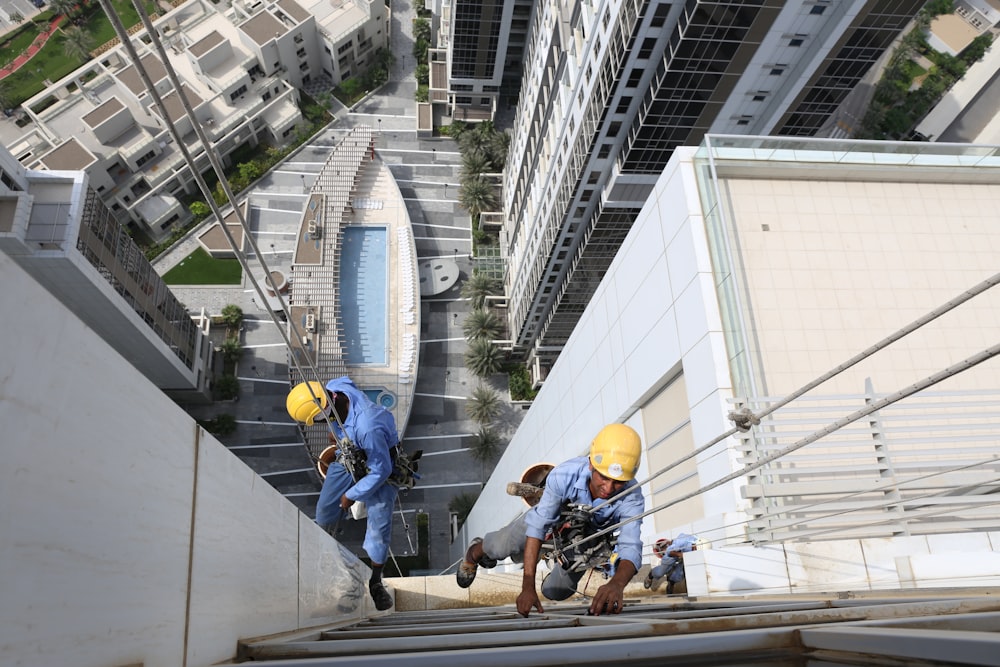 workers hanging on building