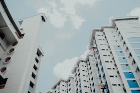 low-angle photo of white building under white sky