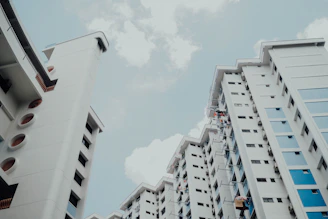 low-angle photo of white building under white sky