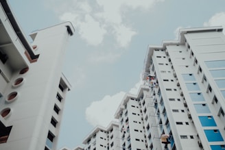 low-angle photo of white building under white sky