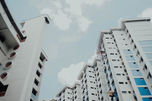 low-angle photo of white building under white sky