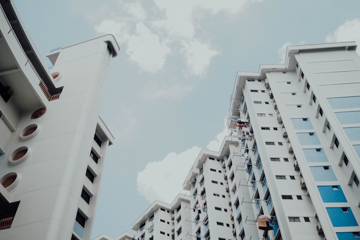 low-angle photo of white building under white sky