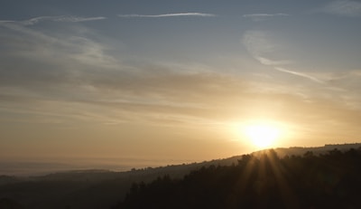A bright sunrise over a horizon, representing new beginnings and hope.