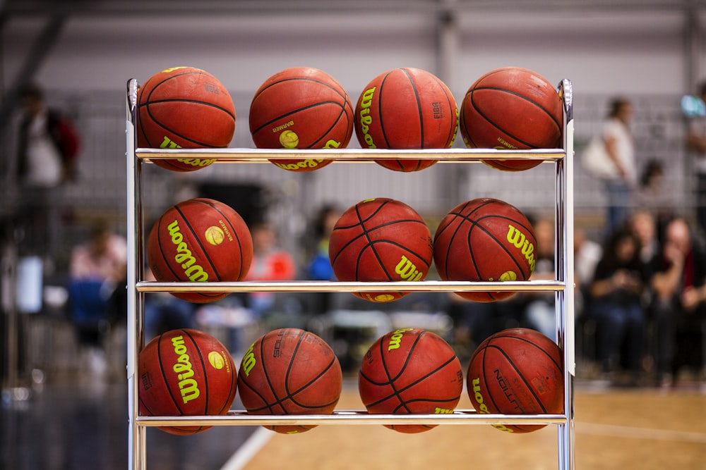 pile of basketballs on rack