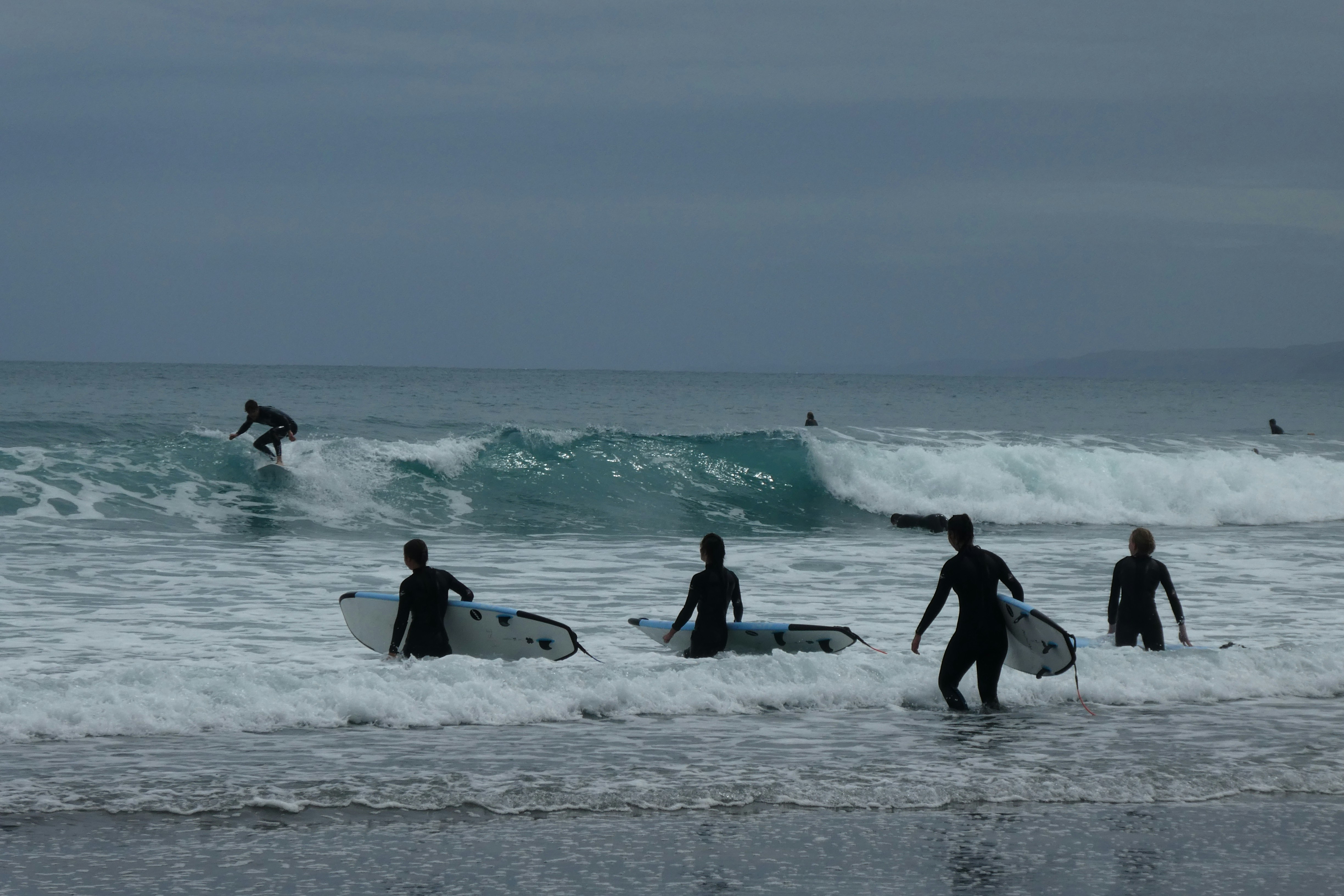 five person playing surfing