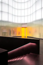 A modern home interior with a levitex lift softly illuminated, showcasing its minimalist design in natural light.