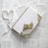 A collection of pages with text scattered around a white, decorative notebook adorned with a floral lace pattern. On top of the notebook lies a small bundle of dried flowers, and a ribbon forms the shape of a heart next to it.