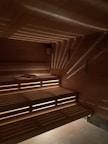 An inviting underground sauna with wooden benches and soft lighting.