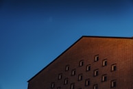 Finished brick facade of a small commercial building under natural sunlight.