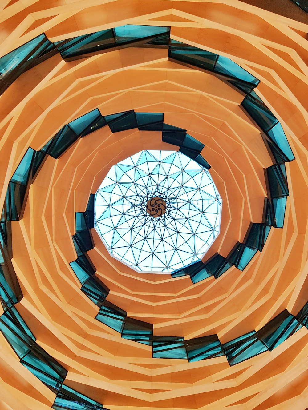 low-angle photography of a spiral building ceiling