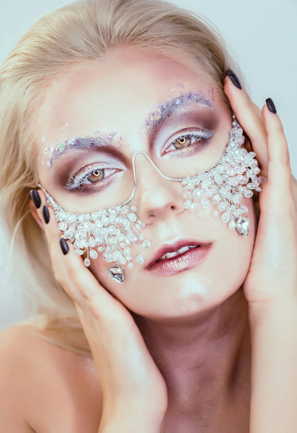 woman with purple rhinestones around her face