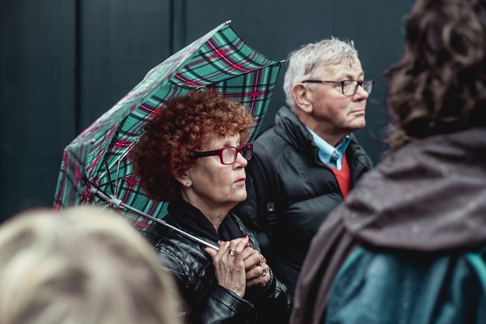 man and woman under green umbrella